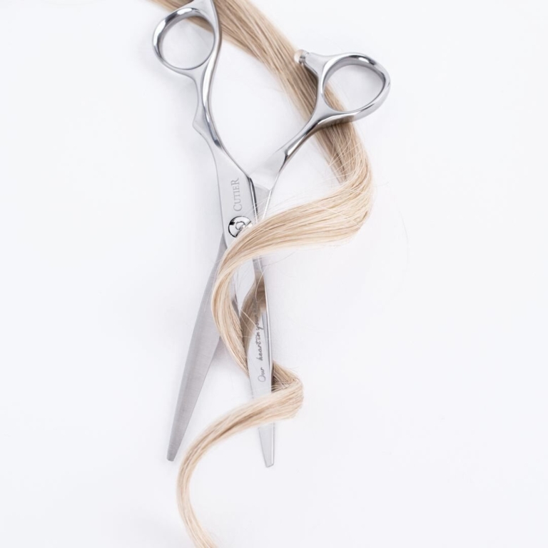 Professional scissors and a blonde curl from a hairdresser Hallam clients visit in Endeavour Hills