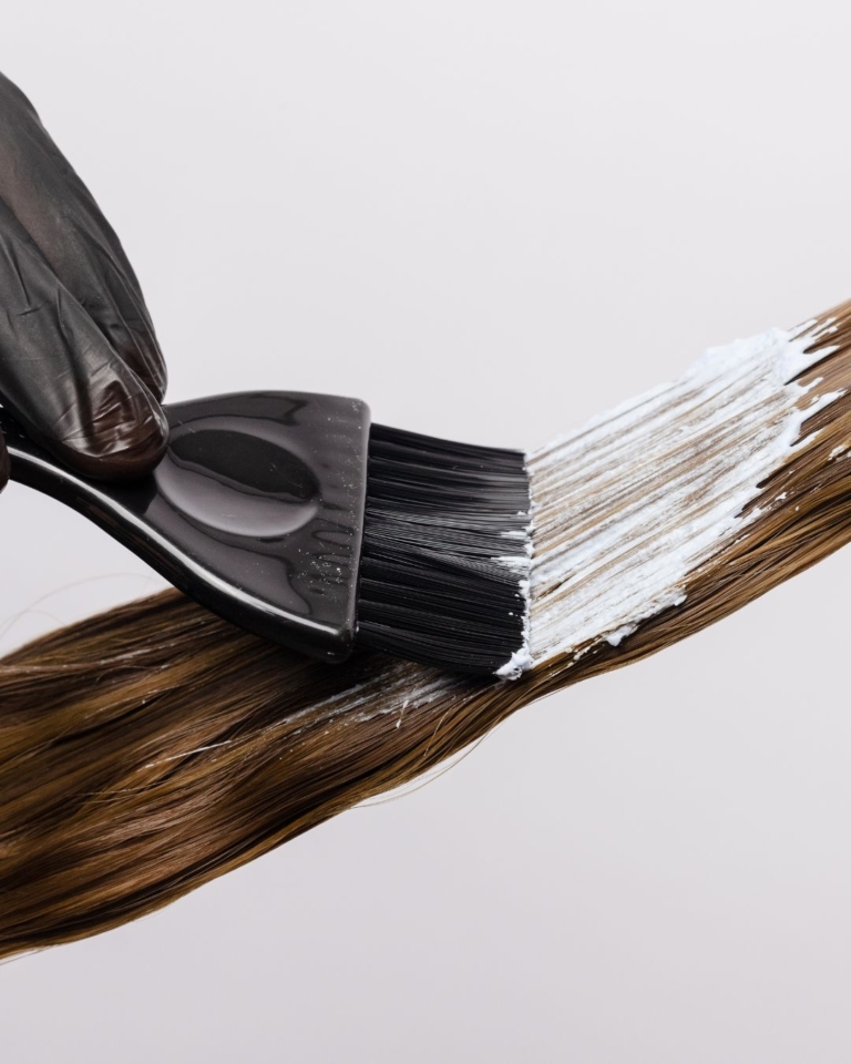 Hair colour being brushed onto brunette hair during colour correction Endeavour Hills appointment