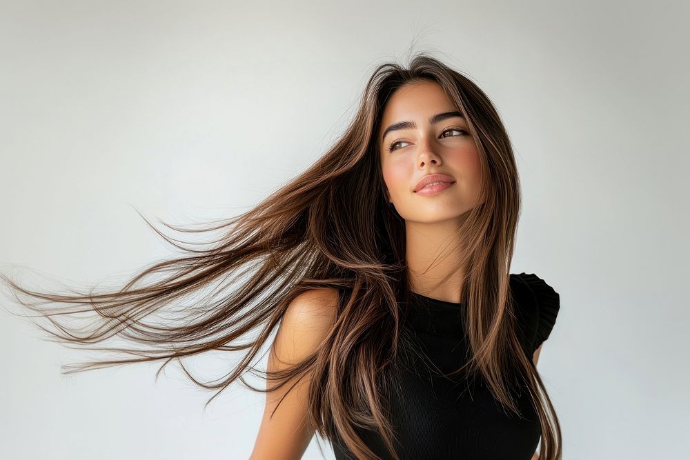 A beautiful woman with long brown straight hair photography portrait flowing. - Sama Hair Salon